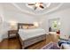 Bright main bedroom featuring tray ceiling, hardwood floors and a sitting room through a doorway at 3714 Westbrooke Ne Cir, Brookhaven, GA 30319