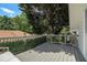 View of a backyard deck with bench seating and privacy hedges at 614 Cooledge Ne Ave, Atlanta, GA 30306