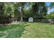 Spacious backyard featuring a storage shed, fire pit, and lush green lawn at 614 Cooledge Ne Ave, Atlanta, GA 30306