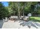 Spacious backyard patio featuring comfortable seating and a serene view of the well-maintained lawn and garden at 614 Cooledge Ne Ave, Atlanta, GA 30306