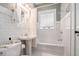 Charming bathroom with a pedestal sink, white tile, and a shower and tub combination at 614 Cooledge Ne Ave, Atlanta, GA 30306