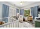 Bright Bedroom with hardwood floors, a crib, and a chair at 614 Cooledge Ne Ave, Atlanta, GA 30306