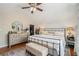 Bright main bedroom with a ceiling fan, hardwood floors, and an attached walk-in closet at 614 Cooledge Ne Ave, Atlanta, GA 30306
