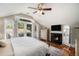 Bright main bedroom features a ceiling fan, balcony access, fireplace, and hardwood floors at 614 Cooledge Ne Ave, Atlanta, GA 30306