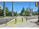Bright street with pedestrian crossing and bollards for safety, surrounded by lush trees and buildings at 614 Cooledge Ne Ave, Atlanta, GA 30306