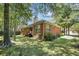 The landscaped backyard with a brick home is ideal for relaxation and outdoor activities at 6718 Oakhurst Ct, Douglasville, GA 30134
