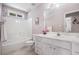 Bright bathroom with white vanity, tub-shower combination, and window at 6718 Oakhurst Ct, Douglasville, GA 30134