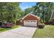Charming brick home with a two-car garage and a well-maintained front yard and a red pickup truck at 6718 Oakhurst Ct, Douglasville, GA 30134