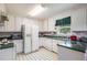 Classic kitchen with white appliances, green countertops, and ample cabinet space at 6718 Oakhurst Ct, Douglasville, GA 30134