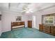 Bright main bedroom featuring a tray ceiling, green carpet, and ample furniture at 6718 Oakhurst Ct, Douglasville, GA 30134