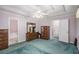 Large main bedroom with tray ceilings, a carpet, and multiple doors at 6718 Oakhurst Ct, Douglasville, GA 30134