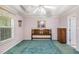 Spacious main bedroom with tray ceiling, a bed with a wood headboard, and green carpet at 6718 Oakhurst Ct, Douglasville, GA 30134