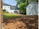 View of a backyard featuring an outdoor storage shed and home with a deck at 6940 Treeline Dr, Cumming, GA 30028