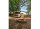 A brick fire pit and wood storage area are in the backyard at 6940 Treeline Dr, Cumming, GA 30028