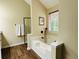 Large tub with black hardware, shower head, and large window at 6940 Treeline Dr, Cumming, GA 30028