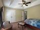 Bedroom featuring a tray ceiling, ceiling fan, walk in closet, and a connecting bathroom at 6940 Treeline Dr, Cumming, GA 30028
