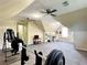 Large bonus room featuring ceiling fans, rubber flooring, with a workspace, and gym equipment at 6940 Treeline Dr, Cumming, GA 30028