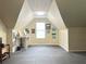 Bonus room with a sloped ceiling, a work area with desk, and natural light from a large window at 6940 Treeline Dr, Cumming, GA 30028