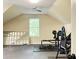 Open bonus room with a ceiling fan, window, and rubber flooring; perfect for a home gym or office at 6940 Treeline Dr, Cumming, GA 30028