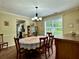 Traditional dining room with large window, crown molding and seating for six people at 6940 Treeline Dr, Cumming, GA 30028