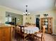 Bright formal dining room features seating for six and access to the kitchen at 6940 Treeline Dr, Cumming, GA 30028