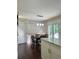 Eat-in kitchen features pendant lighting, hardwood floors, and a door to the back yard at 6940 Treeline Dr, Cumming, GA 30028