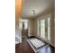 Inviting foyer with hardwood floors, decorative rug, and glass-paneled double entry doors at 6940 Treeline Dr, Cumming, GA 30028