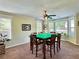 Bright game room with a multi-colored ceiling fan and game table with windows providing natural light at 6940 Treeline Dr, Cumming, GA 30028