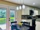 Eat-in kitchen features pendant lighting, granite countertops, stainless steel appliances, and a door to the outside at 6940 Treeline Dr, Cumming, GA 30028