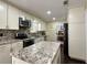 Beautiful kitchen features granite countertops, an island, stainless steel appliances, and mosaic tile backsplash at 6940 Treeline Dr, Cumming, GA 30028