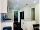 Kitchen features granite counters, island, stainless steel appliances, mosaic backsplash, and dark hardwood floors at 6940 Treeline Dr, Cumming, GA 30028