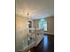 Upper landing with railing, modern light fixture, and hardwood floors at 6940 Treeline Dr, Cumming, GA 30028