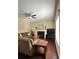 Cozy living room features a fireplace, lots of seating, neutral paint, hardwood floors, and a ceiling fan at 6940 Treeline Dr, Cumming, GA 30028