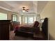 Spacious main bedroom features a tray ceiling, ceiling fan, and large windows for plenty of natural light at 6940 Treeline Dr, Cumming, GA 30028