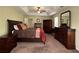 Spacious main bedroom with tray ceiling, ceiling fan and dark wood furniture with ample storage at 6940 Treeline Dr, Cumming, GA 30028