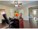 Home office with hardwood floors, a ceiling fan, and desk setup with great lighting at 6940 Treeline Dr, Cumming, GA 30028