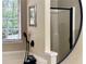 Shower featuring matte black hardware behind a mirror at 6940 Treeline Dr, Cumming, GA 30028
