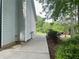 Exterior view of the side yard and patio, highlighting the home's well maintained landscaping at 6940 Treeline Dr, Cumming, GA 30028