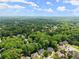Extensive treetop views showcasing the large, lush neighborhood and beautiful skyline in the distance at 1172 Malvern Hunt Ct, Lawrenceville, GA 30043