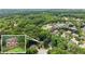 An aerial image of the property and neighborhood, emphasizing the tree cover and neighborhood layout at 1172 Malvern Hunt Ct, Lawrenceville, GA 30043