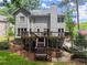 The home showcases a deck, stairs, a brick firepit, and a well-kept lawn enhancing outdoor living at 1172 Malvern Hunt Ct, Lawrenceville, GA 30043