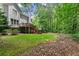 Home's exterior with a deck, steps, and extensive yard, providing a perfect blend of comfort and nature at 1172 Malvern Hunt Ct, Lawrenceville, GA 30043