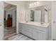Bathroom featuring a double vanity, and doorway leading into the bedroom at 1172 Malvern Hunt Ct, Lawrenceville, GA 30043