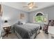 Comfortable bedroom featuring natural light, ceiling fan, rocking chair, and neutral tones at 1172 Malvern Hunt Ct, Lawrenceville, GA 30043