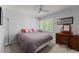 Cozy bedroom with natural light from the window and furniture that includes a desk, and bed at 1172 Malvern Hunt Ct, Lawrenceville, GA 30043