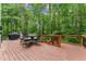 Inviting deck area with seating and a grill, offering a serene outdoor experience surrounded by lush greenery at 1172 Malvern Hunt Ct, Lawrenceville, GA 30043