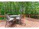 Outdoor deck featuring comfortable seating, perfect for relaxing and enjoying the wooded surroundings at 1172 Malvern Hunt Ct, Lawrenceville, GA 30043
