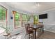 Sunlit dining area with large windows, a wood table, and seating for four at 1172 Malvern Hunt Ct, Lawrenceville, GA 30043