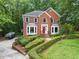 Charming two-story brick home with a landscaped yard and a bright red front door at 1172 Malvern Hunt Ct, Lawrenceville, GA 30043