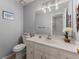 Neutral half bathroom with white vanity, modern lighting, and decorative accents at 1172 Malvern Hunt Ct, Lawrenceville, GA 30043